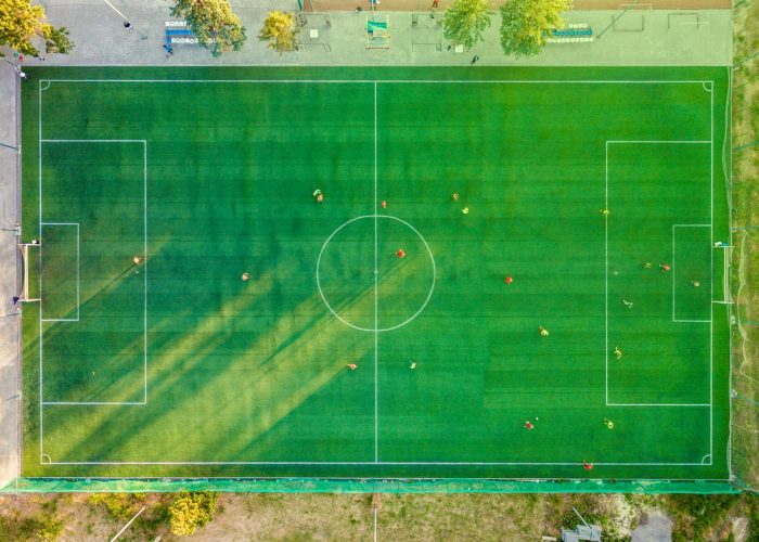 pexels-photo-1171084-1171084 Aerial shot of a soccer game with players on a vibrant green field.